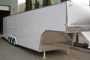 Large, tri-axle, gooseneck race car trailer from Motorsport Hauler